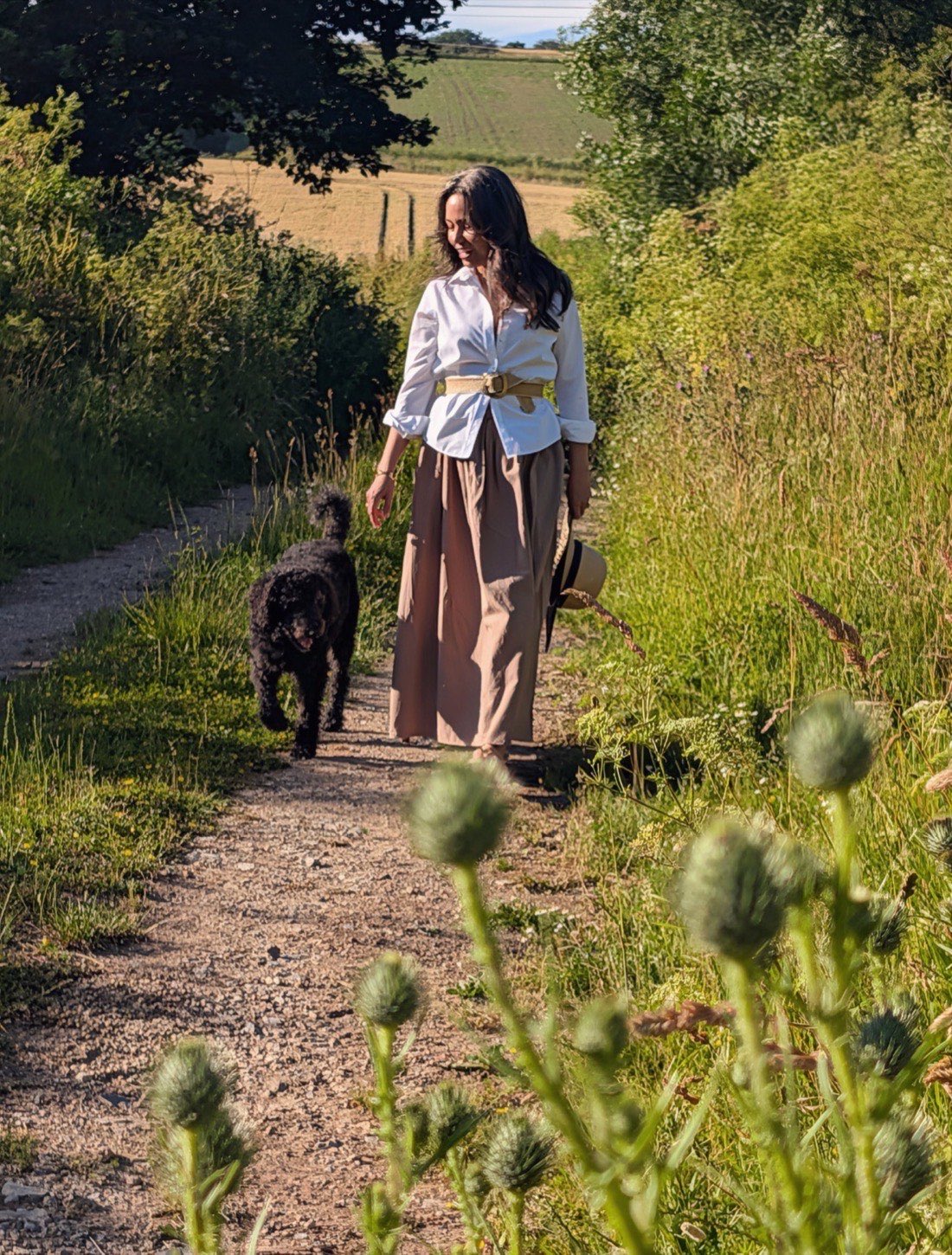 Nina Hearn walking her dog through the countryside