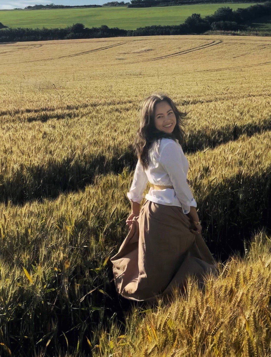 Nina Hearn, nutritional therapist, in a golden Somerset field
