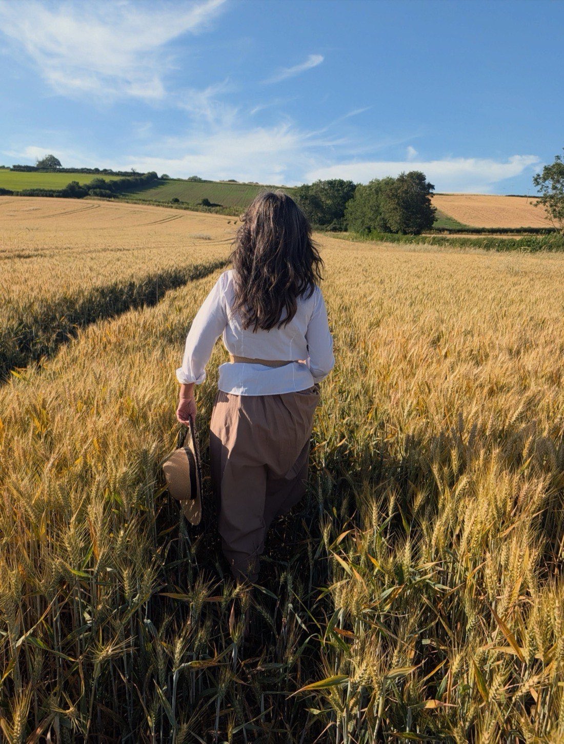 Nina Hearn walking through a golden field